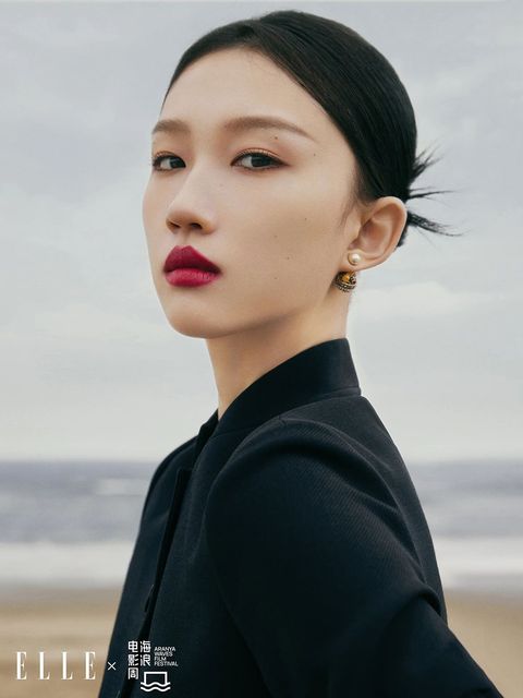 Black top, pearl earrings: both Dior