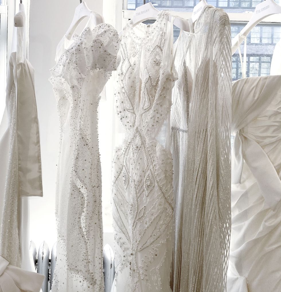 White, Dress, Wedding dress, Room, Textile, Architecture, Bridal clothing, Gown, Bridal party dress, Fashion design, 