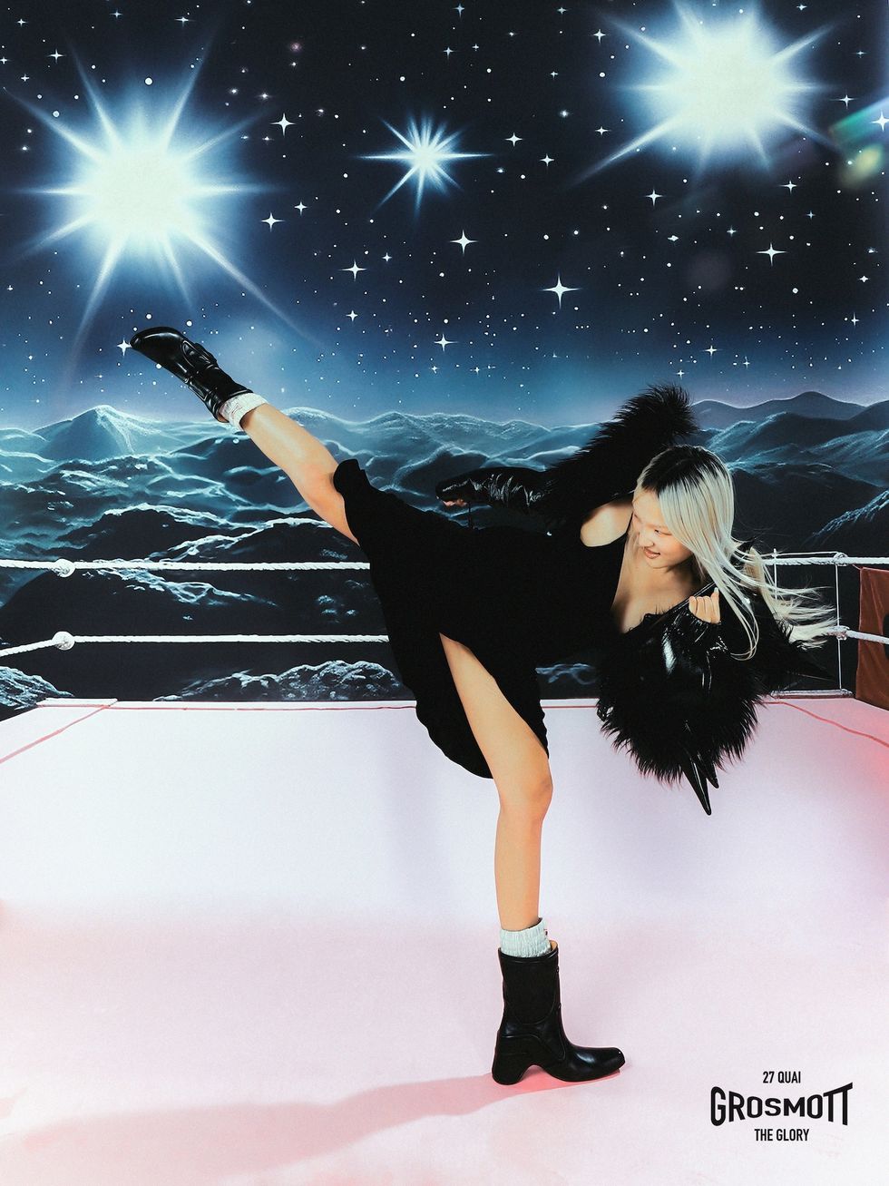 a person in a black dress on ice with a bright light behind the