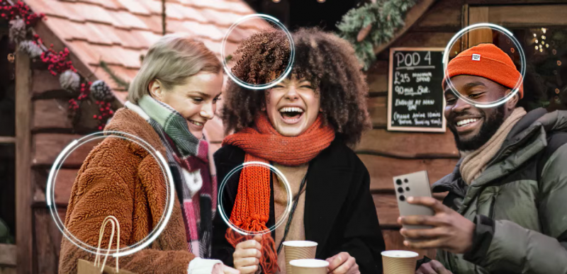 a group of friends enjoying festive drinks in a cozy outdoor market setting