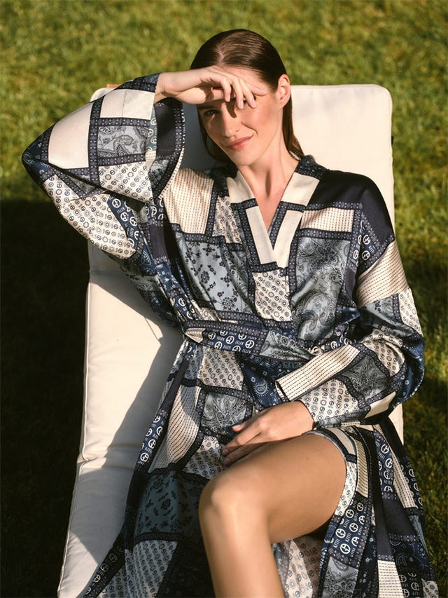 a person relaxing in a patterned robe on a lounge chair in an outdoor setting