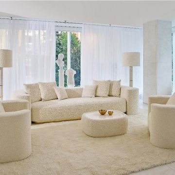 a living room with a large white couch and a large window