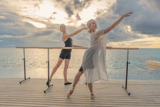 a couple of women posing for a picture on a dock