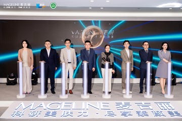 group of people standing in a promotional event with illuminated podiums