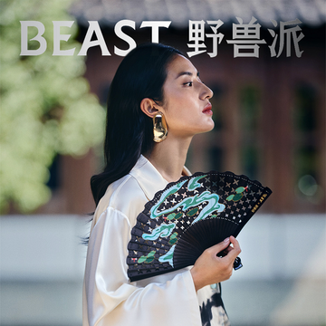 a person holding a decorative fan dressed in an elegant outfit a person holding a decorative fan dressed in an elegant outfit