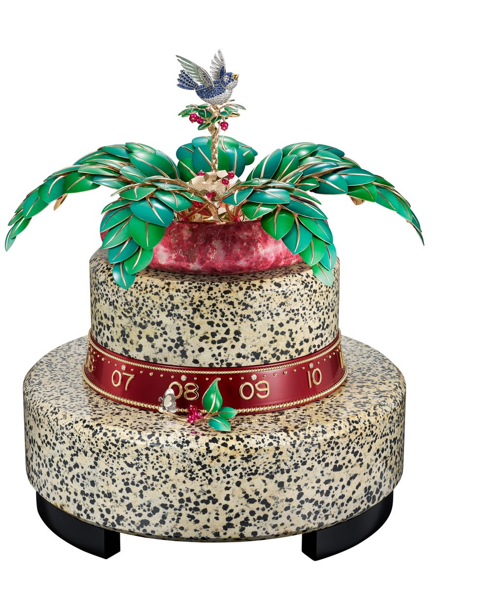 decorative cake with vibrant foliage and a bird atop
