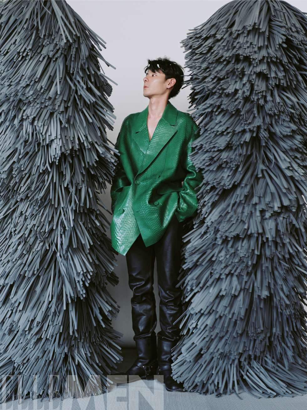 a person stands between two textured installations
