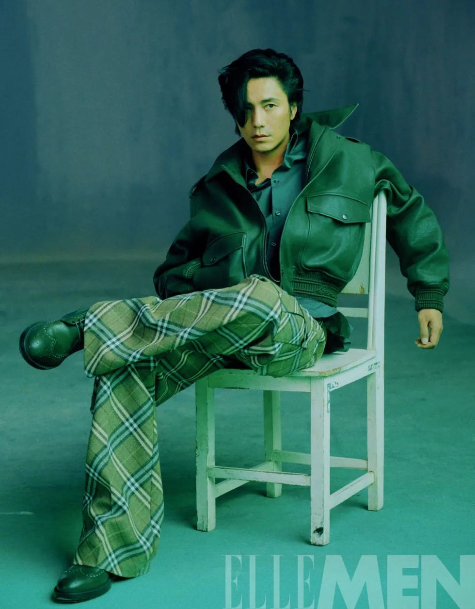 a seated individual in a stylish outfit showcasing modern fashion