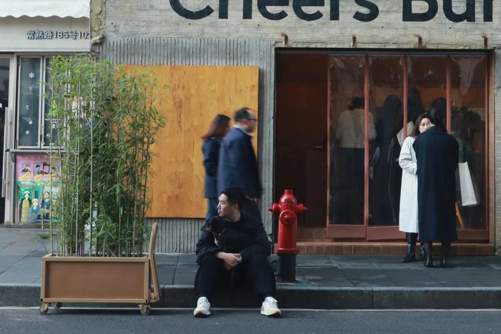 urban street scene with people walking by a restaurant