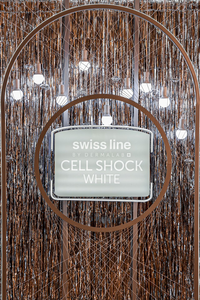 advertising display for swiss line skincare products featuring cell shock white