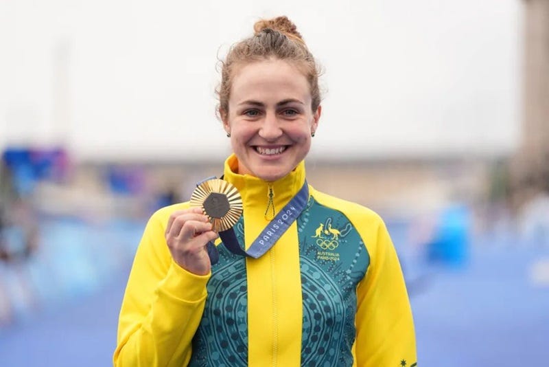 a person holding a gold medal