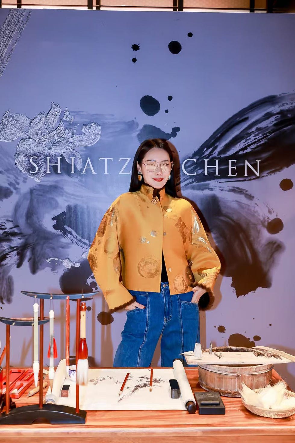 fashion display featuring traditional chinese art materials and attire