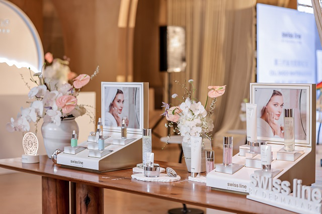 display of swiss line skincare products and floral arrangements at a promotional event