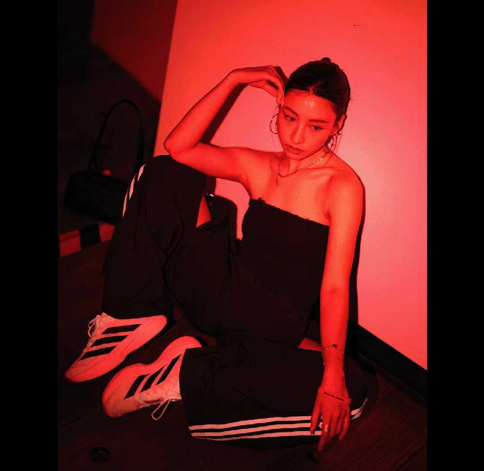 stylized portrayal of a figure in urban attire with a vibrant background