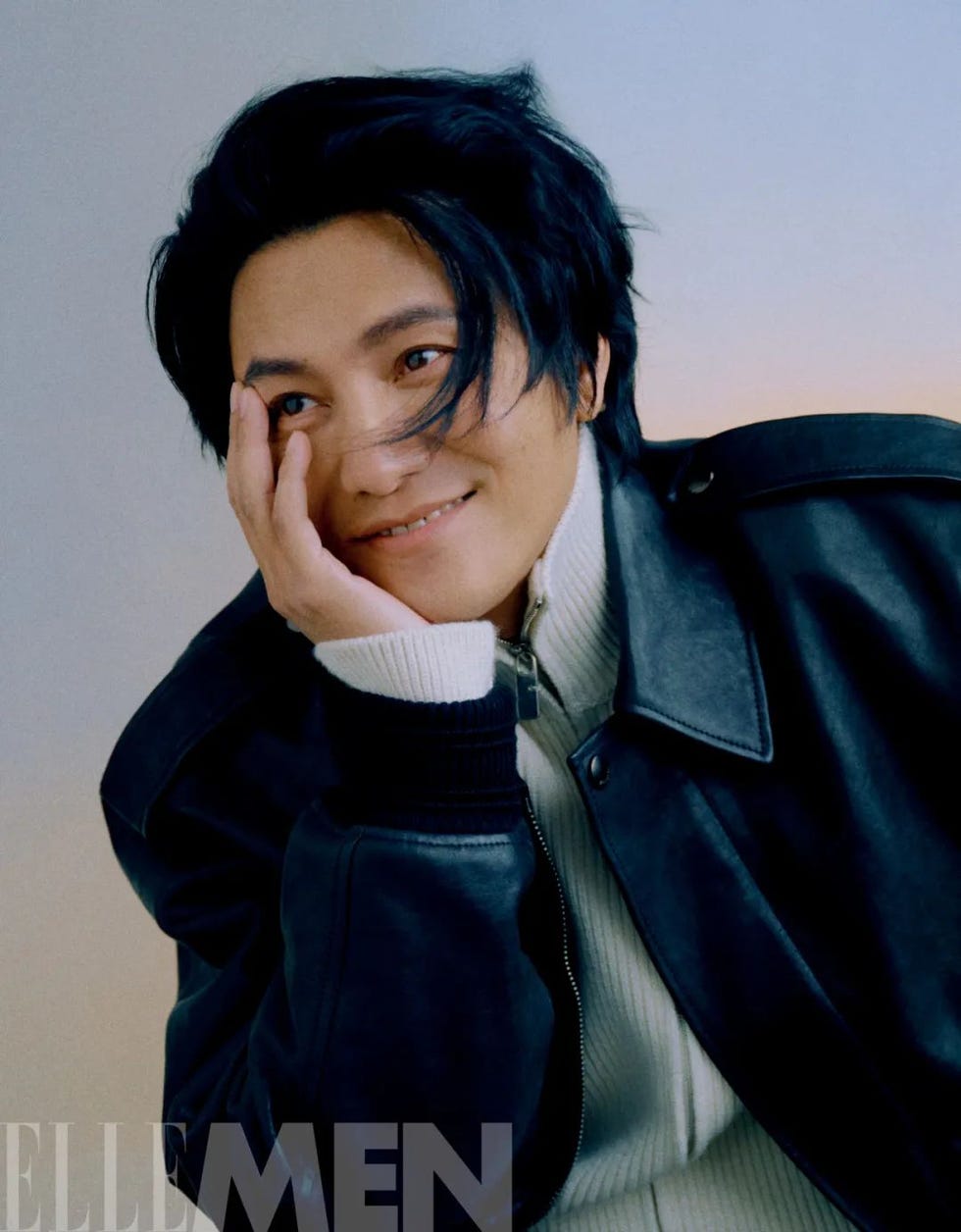 portrait with a subject in a leather jacket and sweater hand on chin