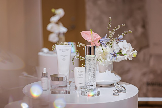 display of skincare products with floral arrangement