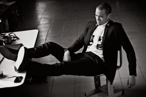 Photograph, Sitting, Footwear, Suit, Photography, Leg, Formal wear, Black-and-white, Tuxedo, Monochrome, 