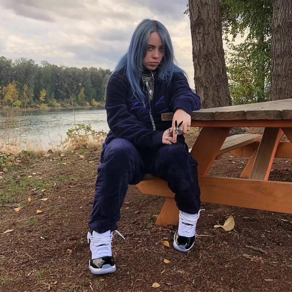 Sitting, Natural environment, Wilderness, Footwear, Cool, Tree, Outerwear, Jeans, Leg, Shoe, 