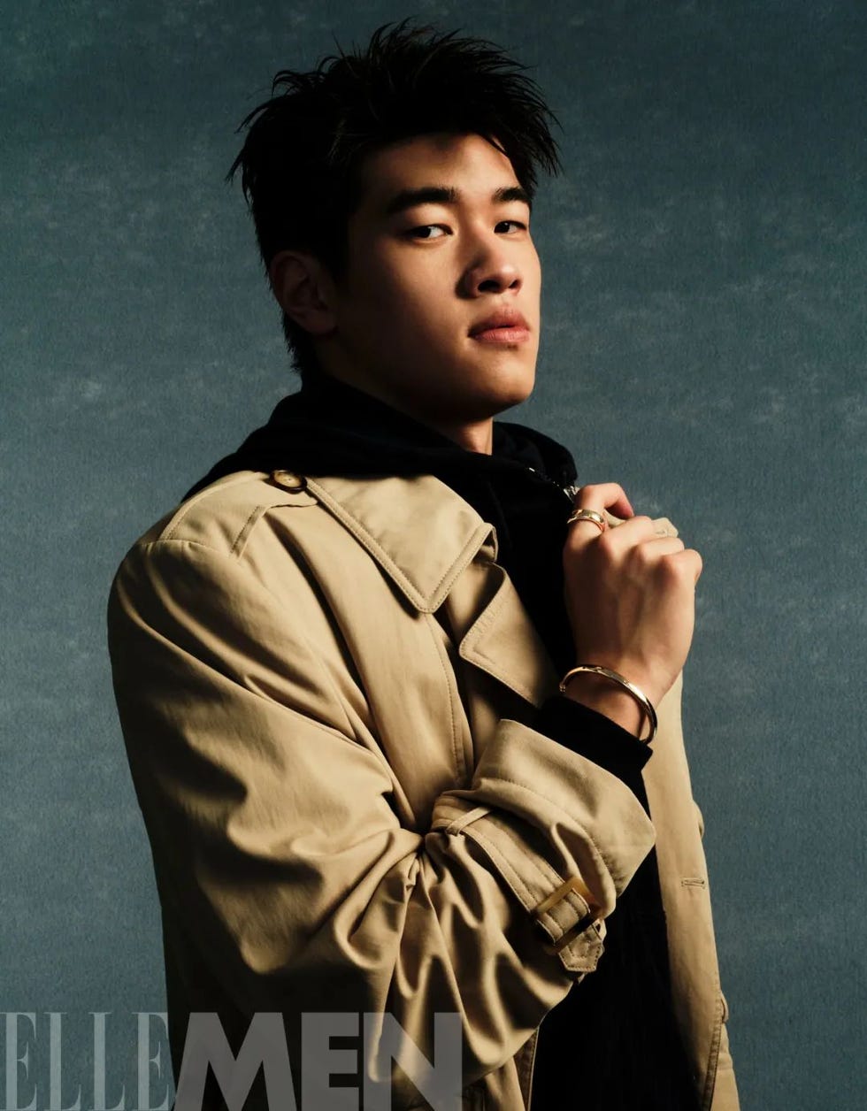 fashion portrait featuring a person wearing a beige trench coat and accessories