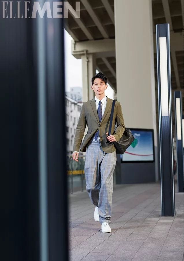 Street fashion, Clothing, Blazer, Suit, Fashion, Standing, Snapshot, Outerwear, Formal wear, Jeans, 