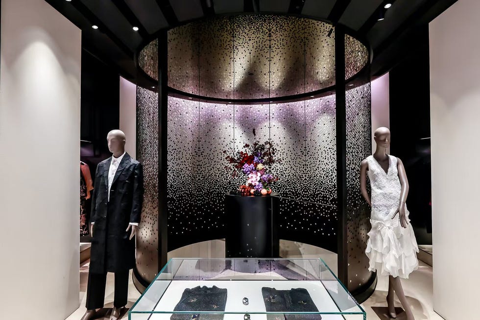 fashion retail display featuring stylish clothing and floral arrangement