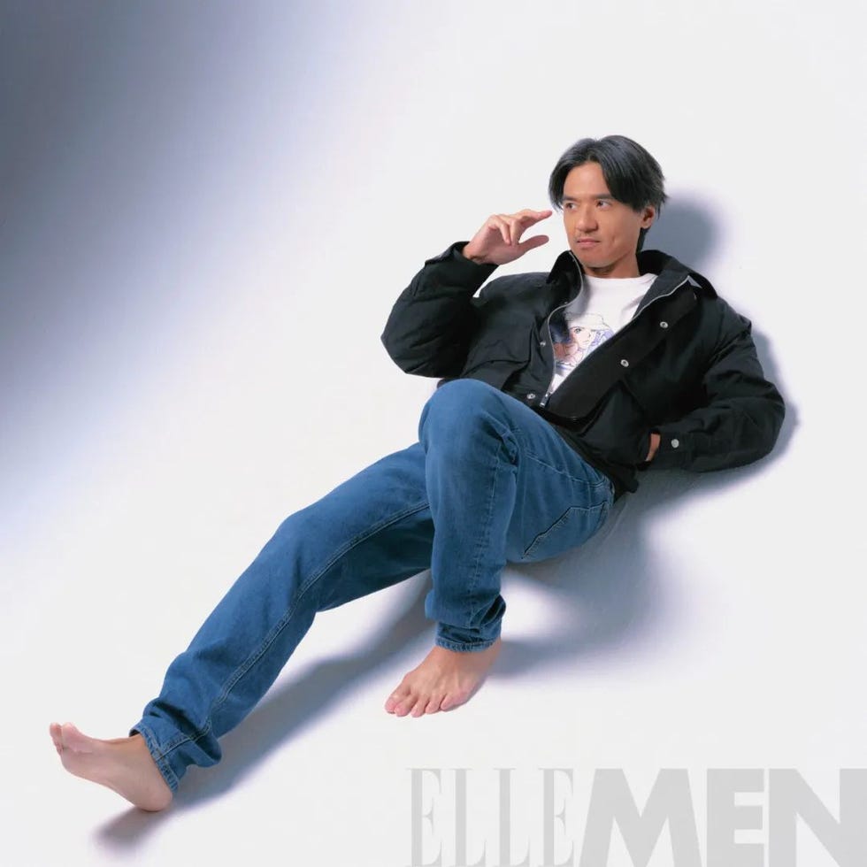a person reclining on the floor dressed in casual clothing