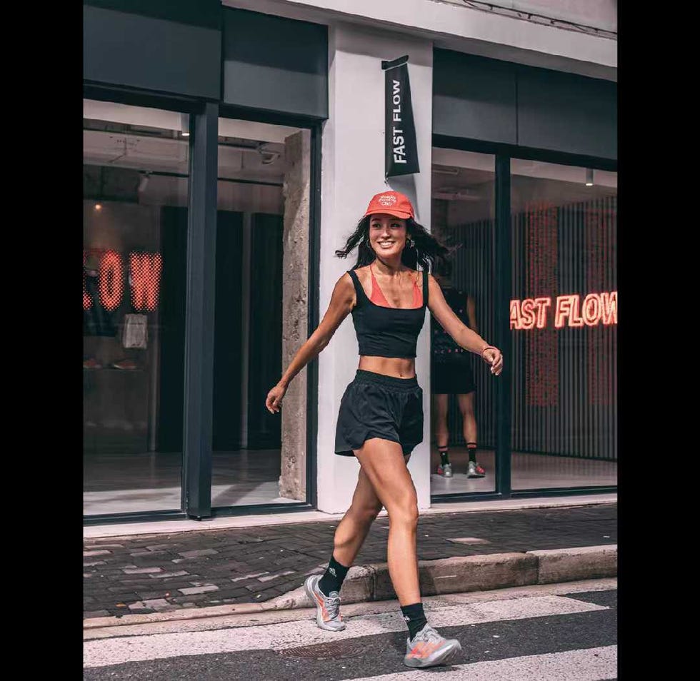 person jogging past a fitnessrelated storefront