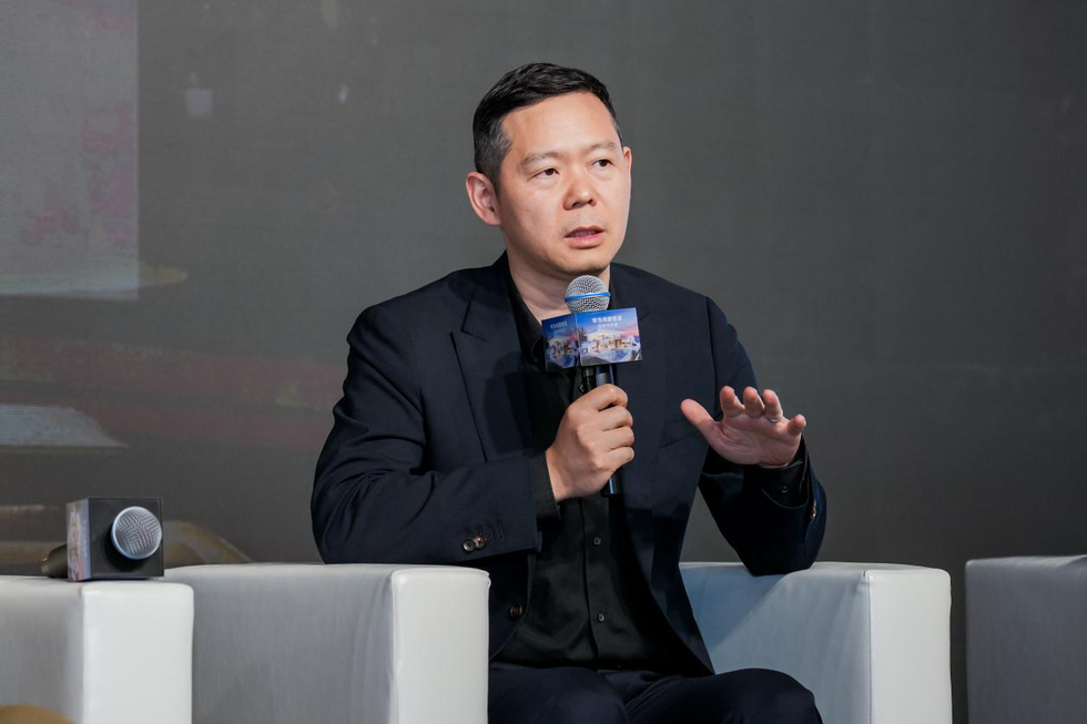 person speaking into a microphone at an event