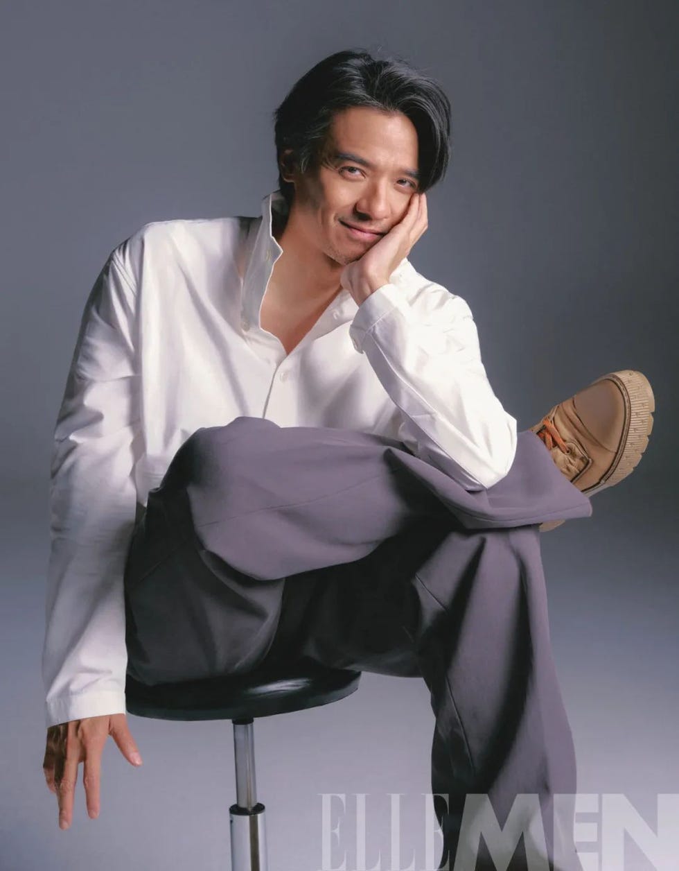 stylish person sitting on a stool in a relaxed pose