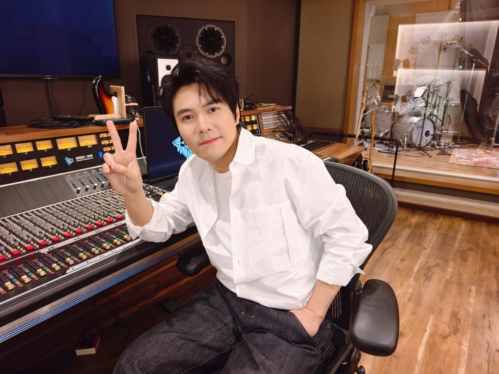 recording studio with a person making a peace sign