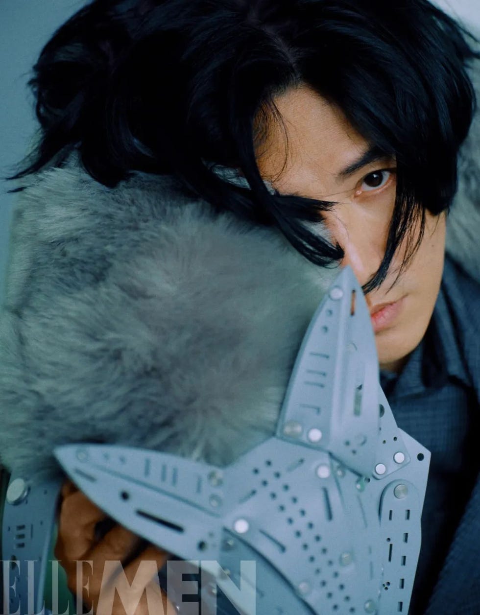 person holding a unique mask with fur details