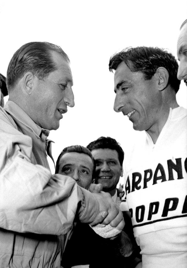 handshake between two individuals with a group in the background