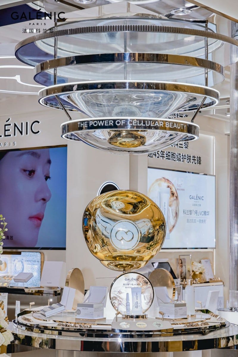 display of skincare products with a golden orb centerpiece at a retail location
