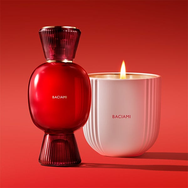 fragrance bottle and candle from baciami on a red background