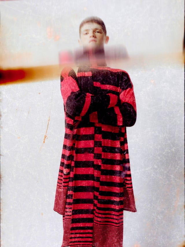 fashion model wearing a striped garment in red and black