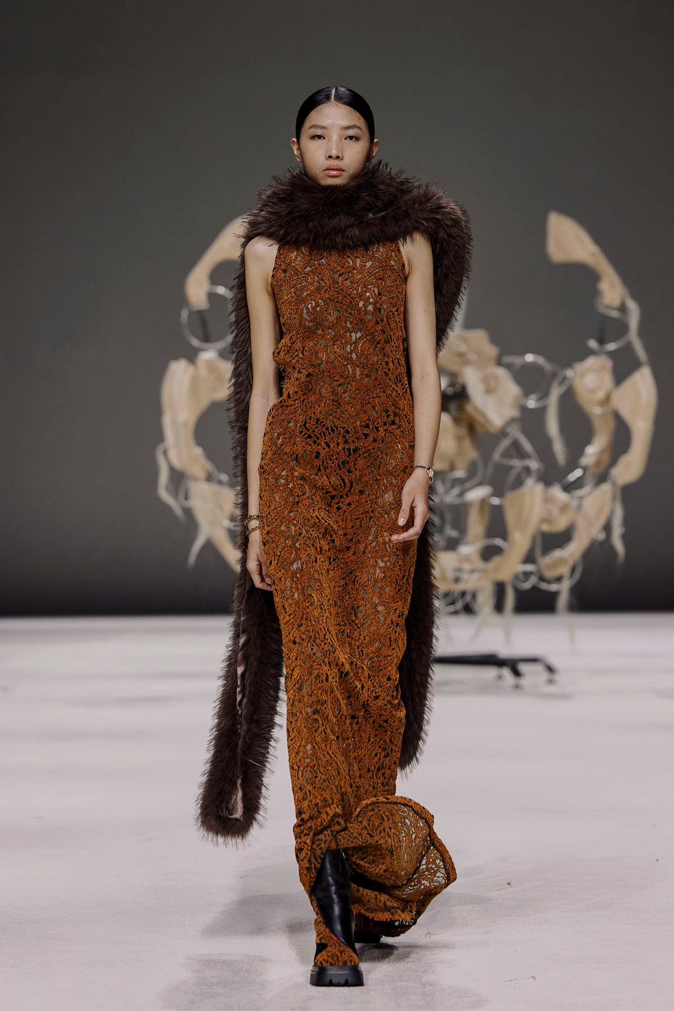 a model showcases a unique fashion design on a runway