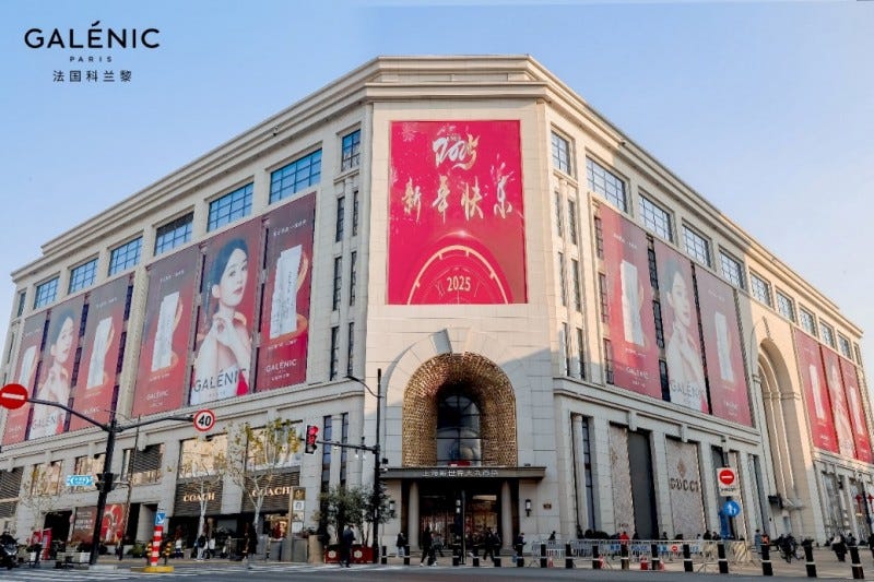 building facade with advertisements for galénic paris and luxury brands