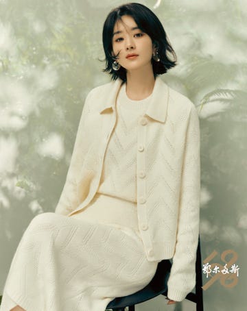 model in creamcolored textured knitwear seated in a chair