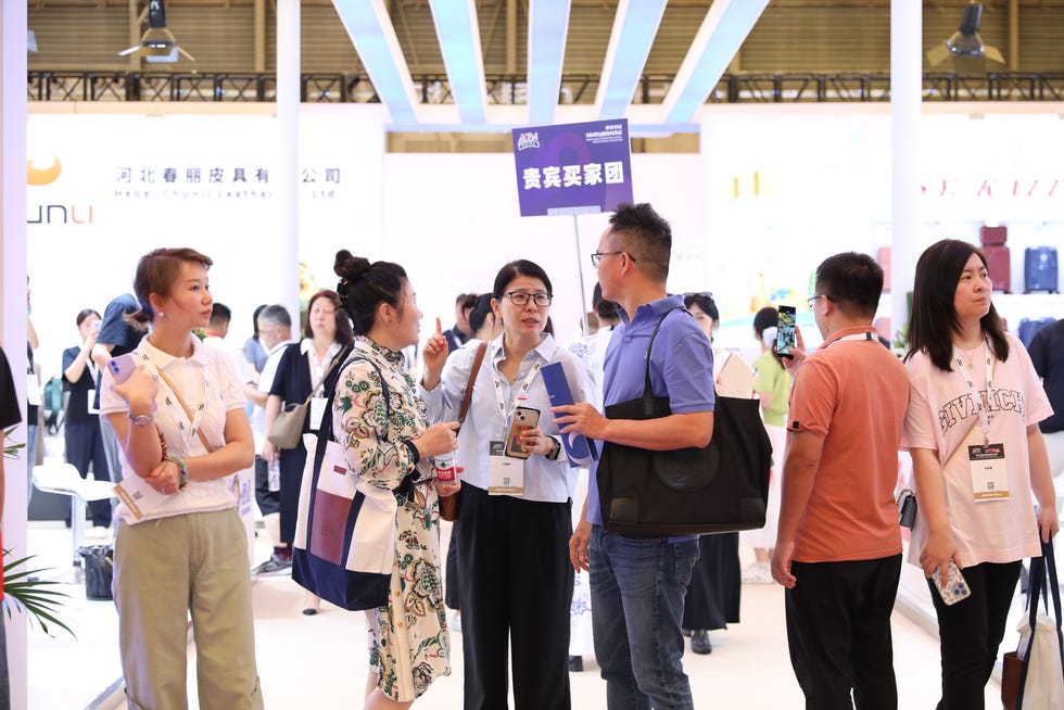 group of people engaged in conversation at a trade exhibition