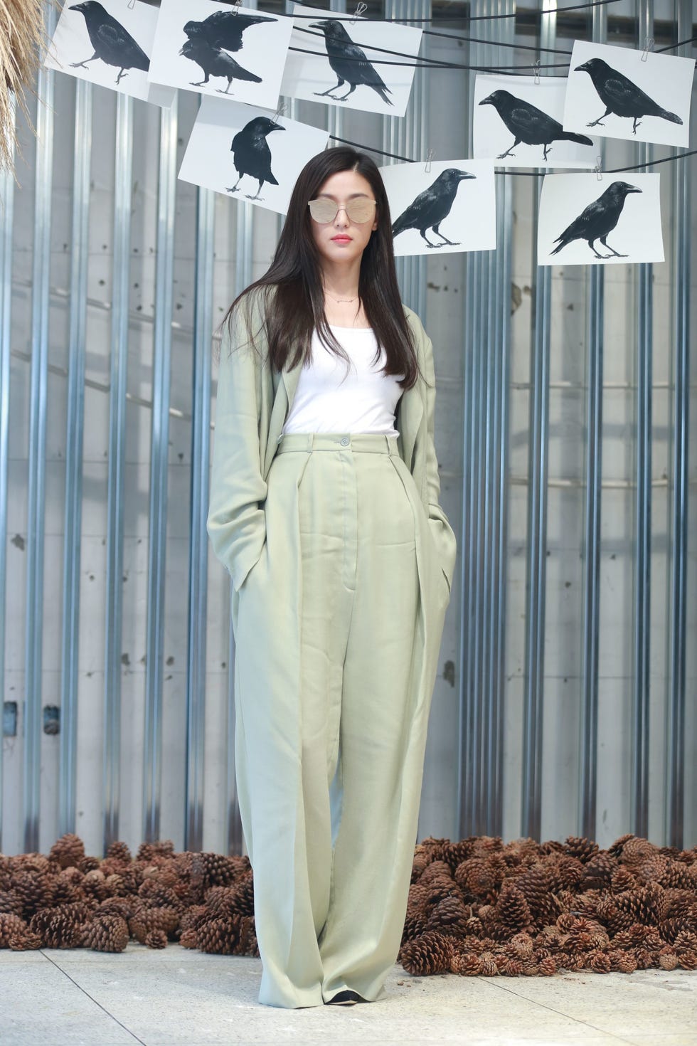 a person standing in front of a wall with a white and black design