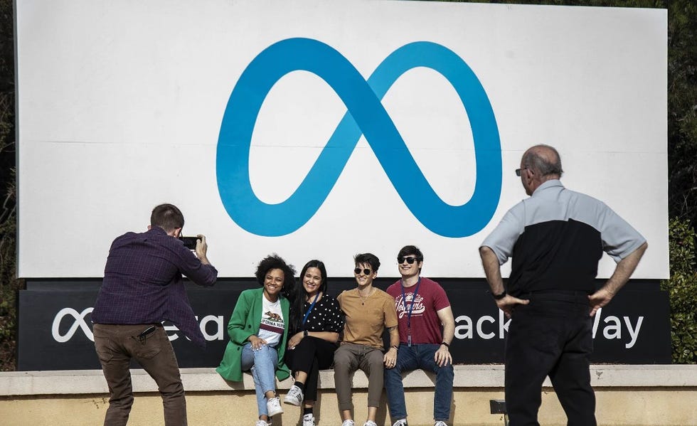 a group of people posing for a photo in front of a sign