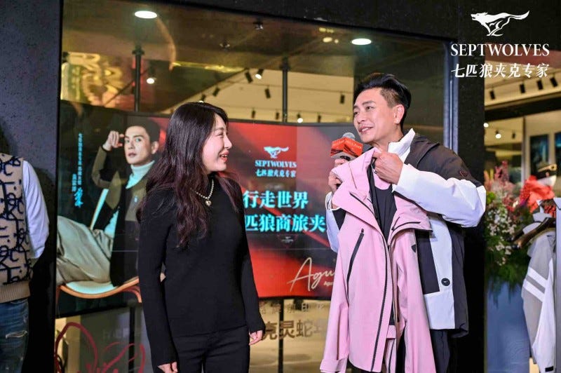 display of clothing in a retail setting with customers interacting