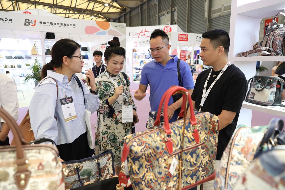 business meeting at a trade show featuring various bags