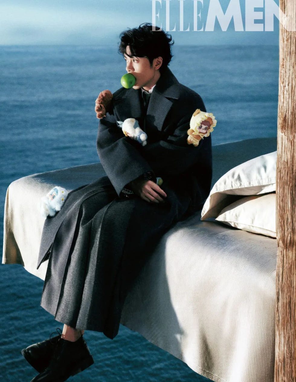 a person seated on an elevated platform with plush toys