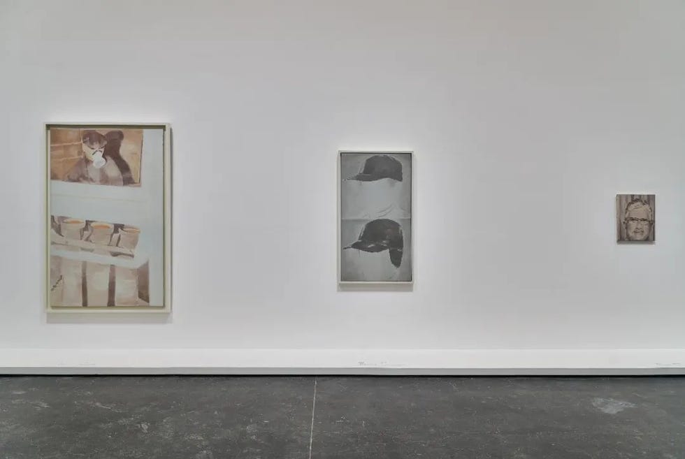 art exhibition featuring framed artworks on a white wall