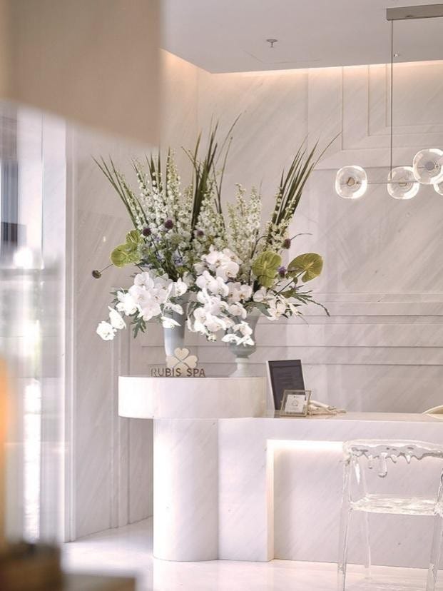 reception area featuring a large floral arrangement and contemporary decor