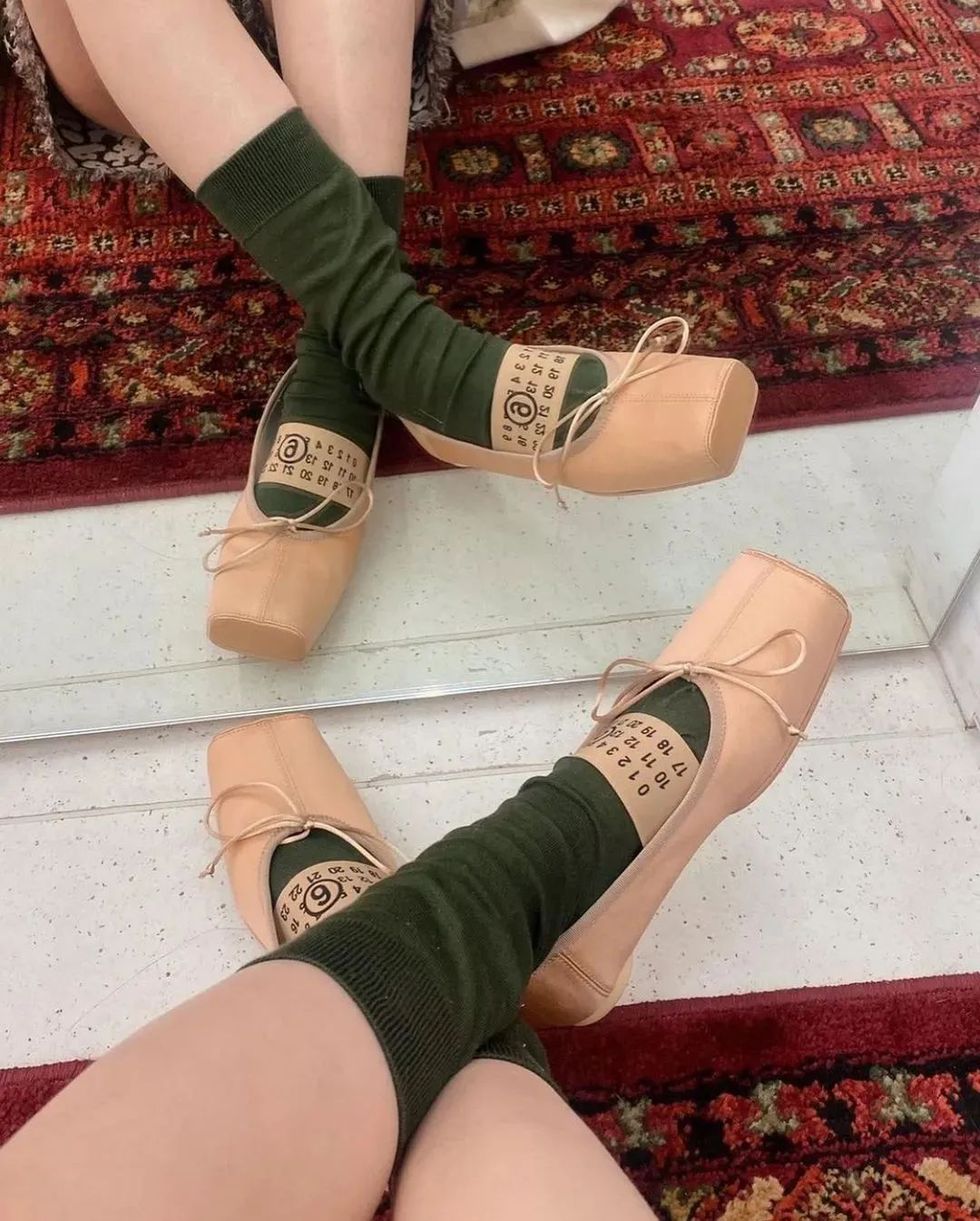 a pair of feet wearing green socks