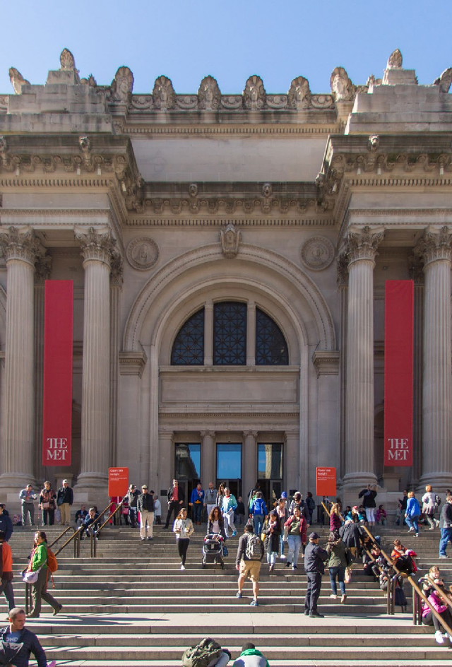entrance to the metropolitan museum of art with visitors