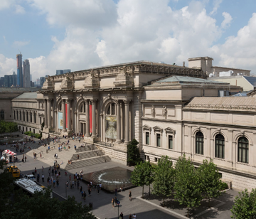 entryway of a large museum with steps leading up to a grand facade
