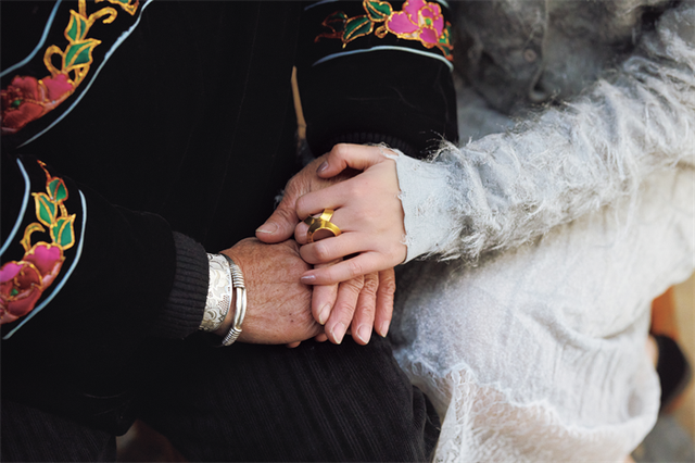 intertwined hands of two individuals showcasing their connection